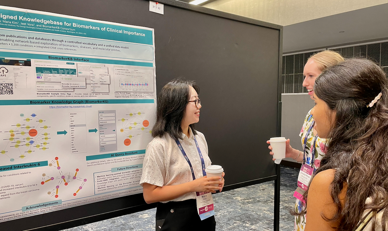 Maria Kim talking to people by poster