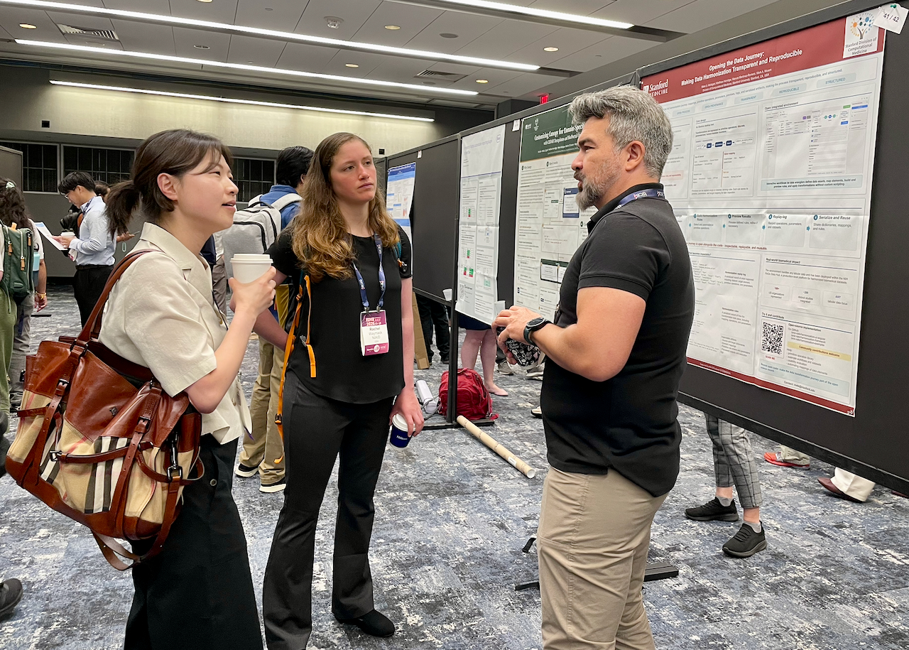 Mete Akdogan and others by poster at BOSC 2026